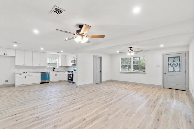 unfurnished living room with sink, ceiling fan, and light hardwood / wood-style flooring