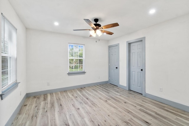 unfurnished bedroom featuring ceiling fan and light hardwood / wood-style floors