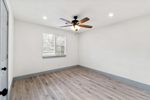 spare room featuring light hardwood / wood-style floors and ceiling fan