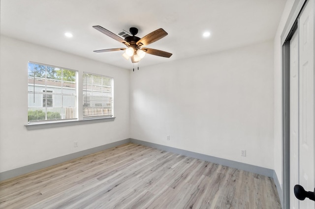 unfurnished bedroom featuring ceiling fan, a closet, and light wood-type flooring