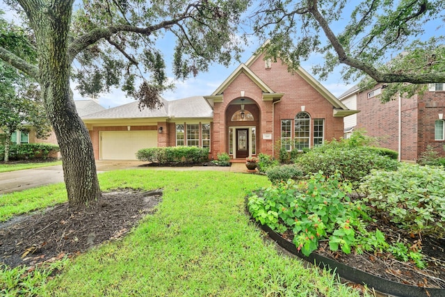 view of front of home with a garage and a front lawn