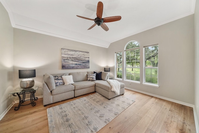 living room with ornamental molding, ceiling fan, and light hardwood / wood-style floors