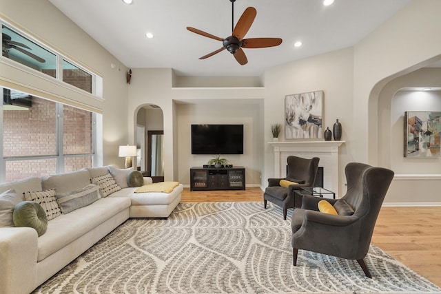 living room featuring ceiling fan and light hardwood / wood-style flooring