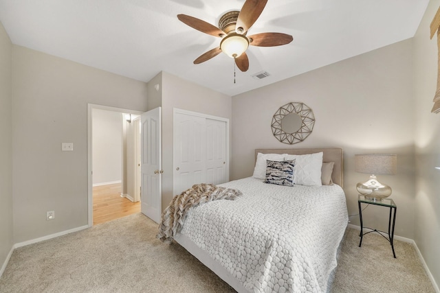 carpeted bedroom with a closet and ceiling fan