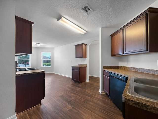 kitchen with dark hardwood / wood-style floors, sink, dishwasher, and a textured ceiling