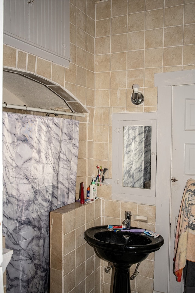 bathroom with tile walls