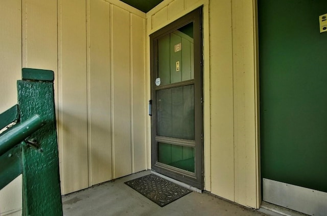 property entrance featuring board and batten siding