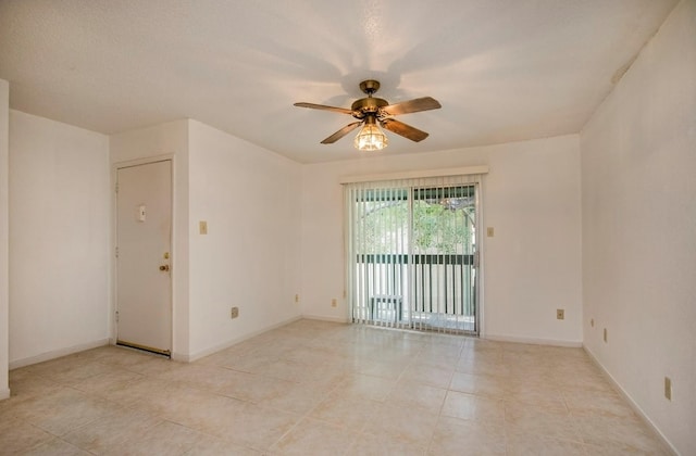 empty room with light tile patterned floors and ceiling fan