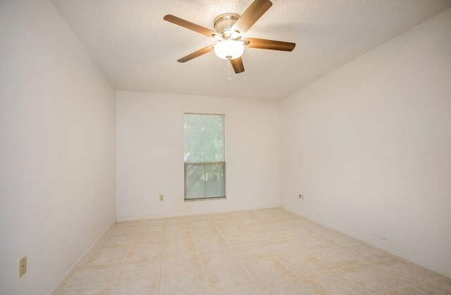 tiled empty room with a textured ceiling and ceiling fan