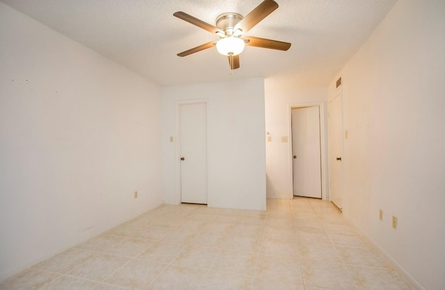 unfurnished room with light tile patterned flooring and ceiling fan