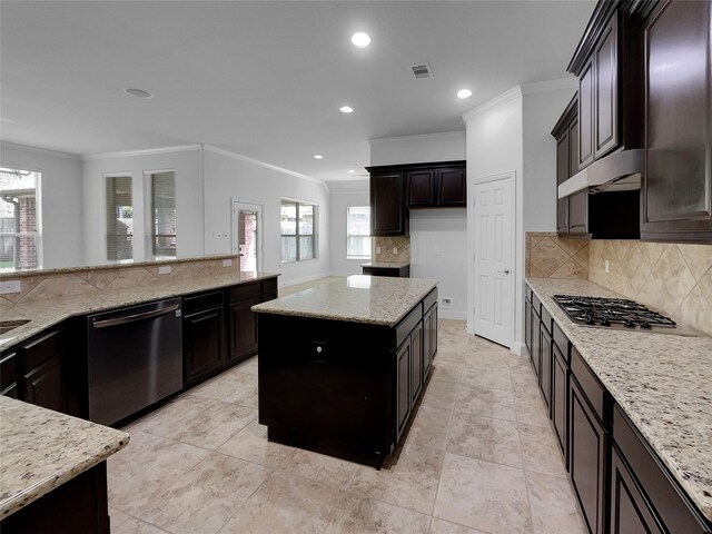 kitchen with stainless steel appliances, decorative backsplash, ornamental molding, a center island, and light stone counters