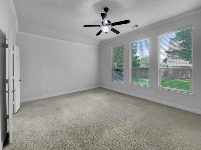 carpeted empty room with ceiling fan and crown molding