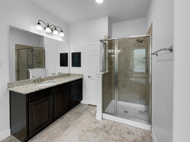 bathroom featuring a shower with door, vanity, and tile patterned flooring