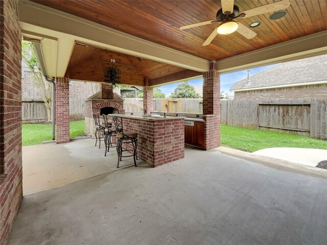 view of patio / terrace featuring a gazebo, ceiling fan, and a bar