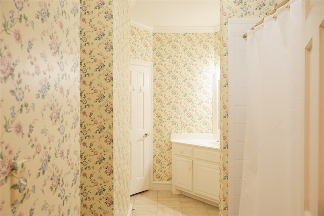 bathroom featuring tile patterned flooring, crown molding, and vanity