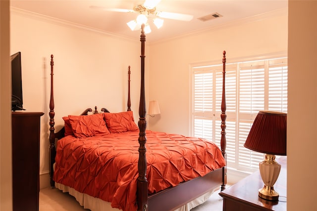 bedroom with carpet floors, crown molding, and ceiling fan