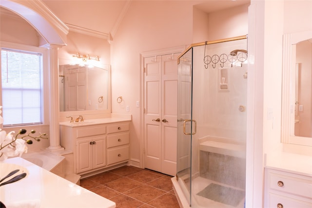 bathroom featuring a shower with shower door, vanity, decorative columns, and tile patterned floors