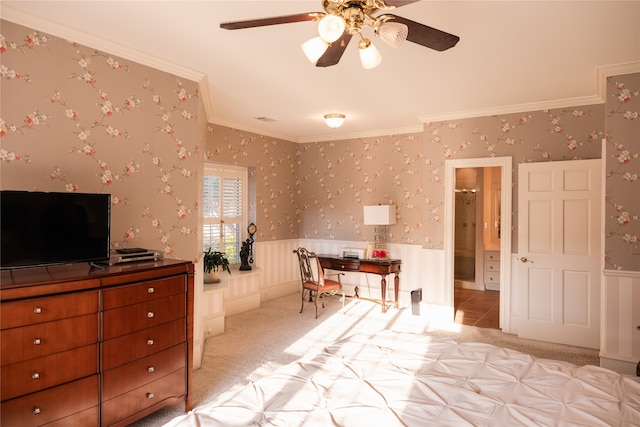 carpeted bedroom with ceiling fan and ornamental molding