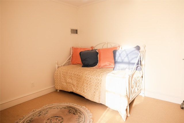 carpeted bedroom with ornamental molding