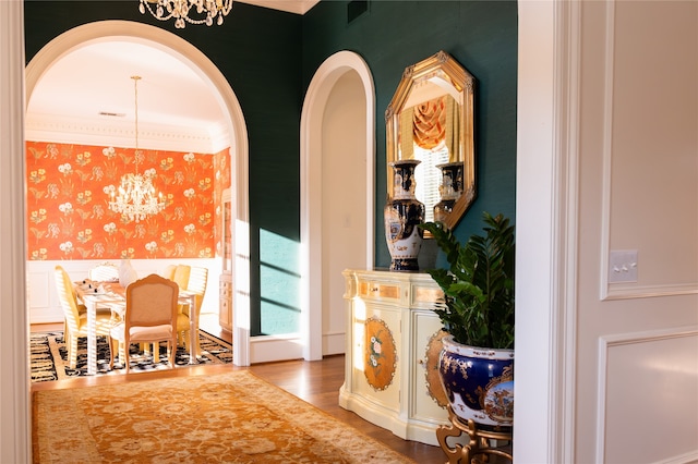 hallway featuring a notable chandelier and light wood-type flooring