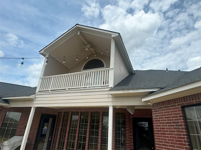 view of home's exterior with a balcony and ceiling fan