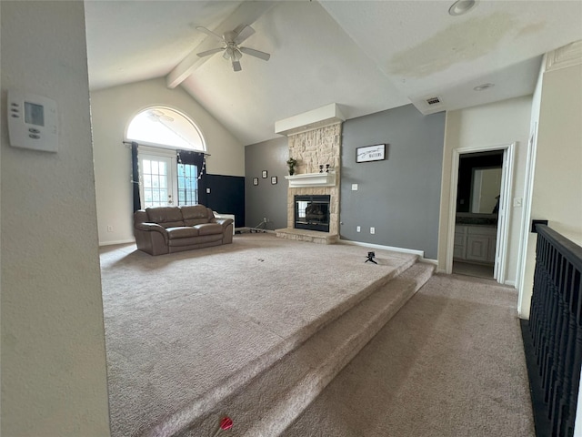 unfurnished living room with high vaulted ceiling, a fireplace, beamed ceiling, carpet floors, and ceiling fan