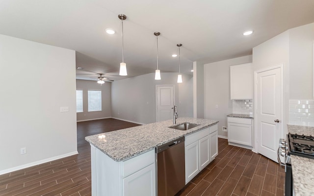 kitchen featuring stainless steel appliances, white cabinets, dark wood-type flooring, sink, and decorative light fixtures