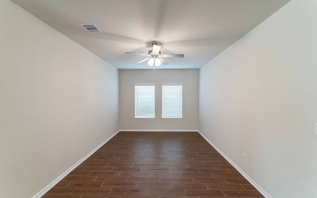 spare room with ceiling fan and dark wood-type flooring