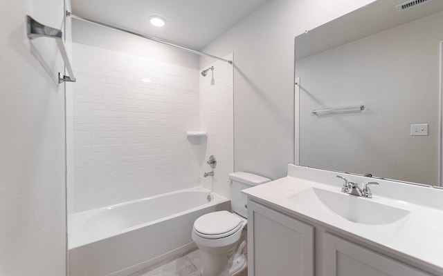 full bathroom featuring tiled shower / bath combo, vanity, and toilet