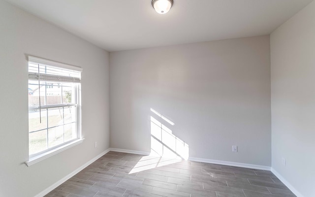 unfurnished room with hardwood / wood-style flooring