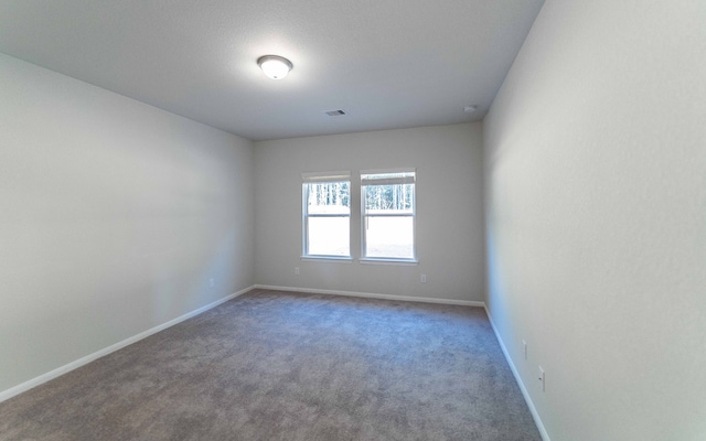 unfurnished room featuring carpet