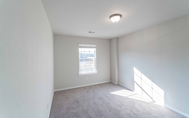 unfurnished room with light carpet