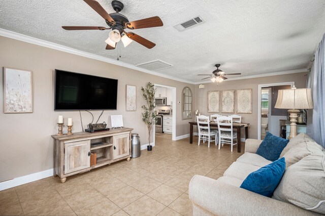 tiled living room with a textured ceiling, ceiling fan, and crown molding