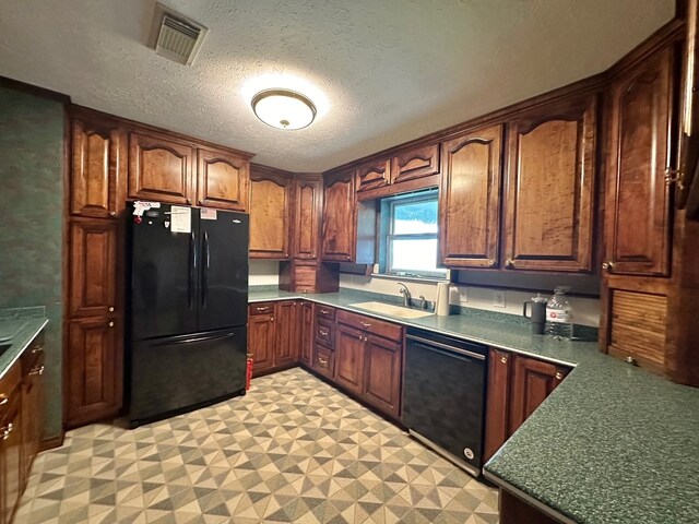 kitchen featuring a textured ceiling, black appliances, sink, and light tile patterned flooring