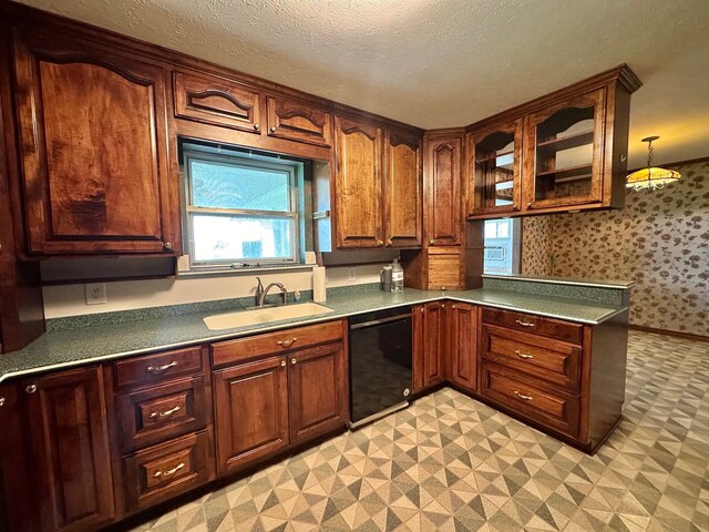 kitchen with light tile patterned floors, dishwasher, and sink