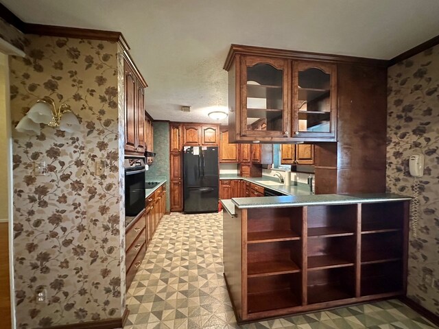 kitchen featuring light tile patterned floors, sink, black appliances, kitchen peninsula, and ornamental molding