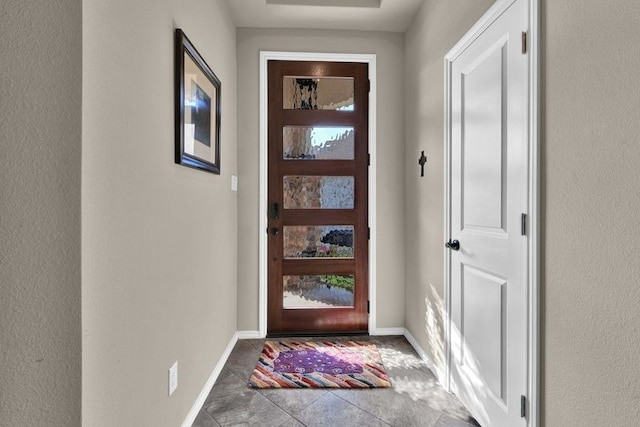 doorway to outside featuring tile patterned floors