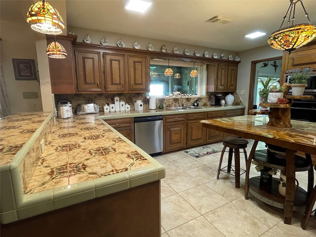 kitchen featuring stainless steel dishwasher, a healthy amount of sunlight, and backsplash