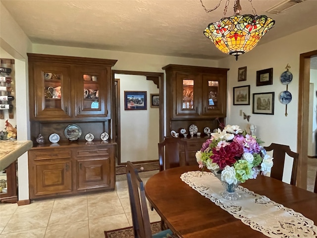 dining space featuring light tile patterned flooring