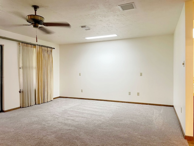 carpeted empty room featuring a textured ceiling and ceiling fan