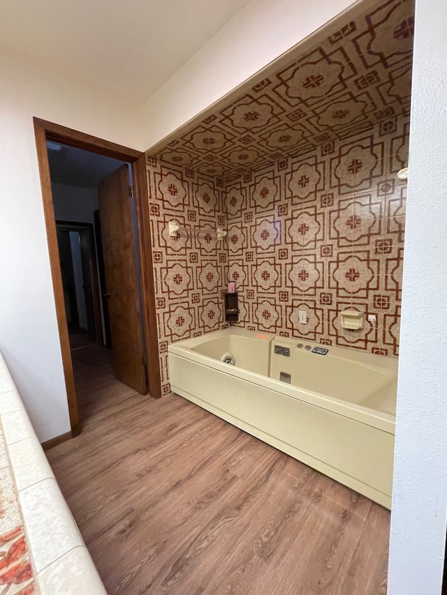 bathroom featuring a bathing tub and wood-type flooring