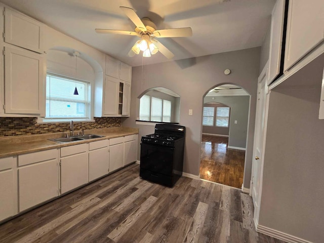 kitchen with black gas stove, sink, and white cabinets