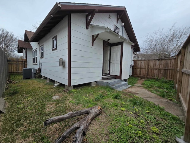 rear view of house with central AC unit