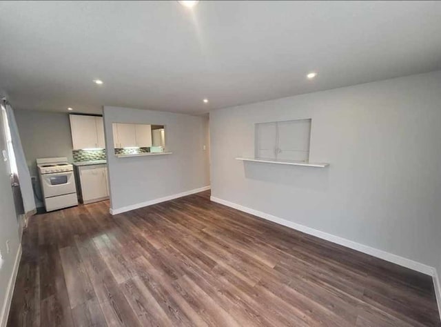 unfurnished living room with dark hardwood / wood-style floors