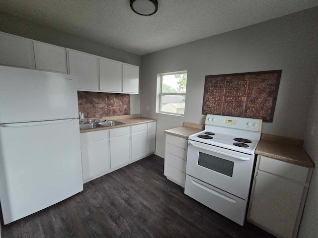 kitchen featuring dark hardwood / wood-style floors, white cabinetry, sink, and white appliances