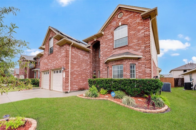 view of front property with a garage, central AC unit, and a front lawn