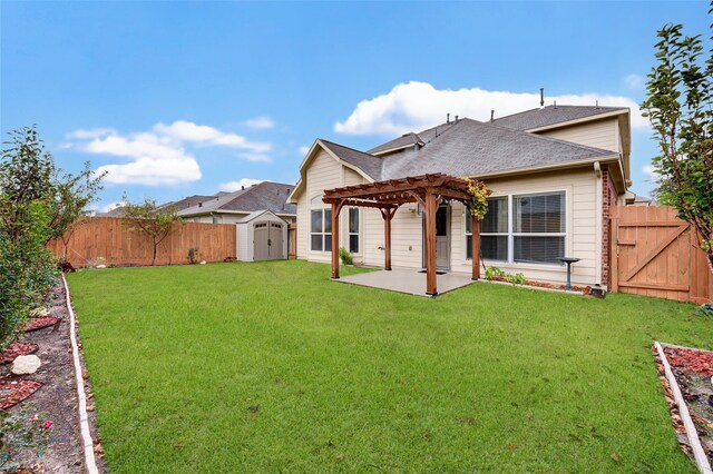 rear view of property with a shed, a yard, a pergola, and a patio