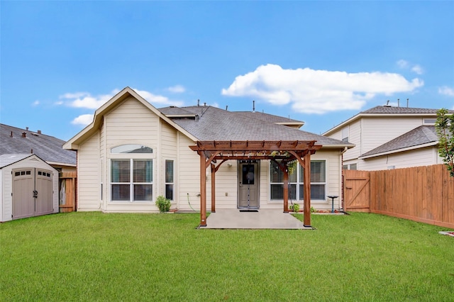 back of house featuring a storage shed, a yard, a pergola, and a patio