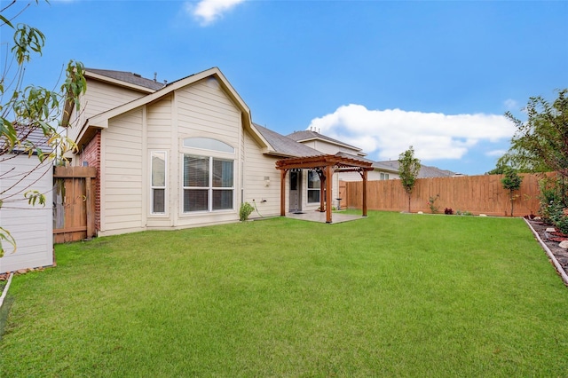 rear view of property with a yard, a pergola, and a patio area