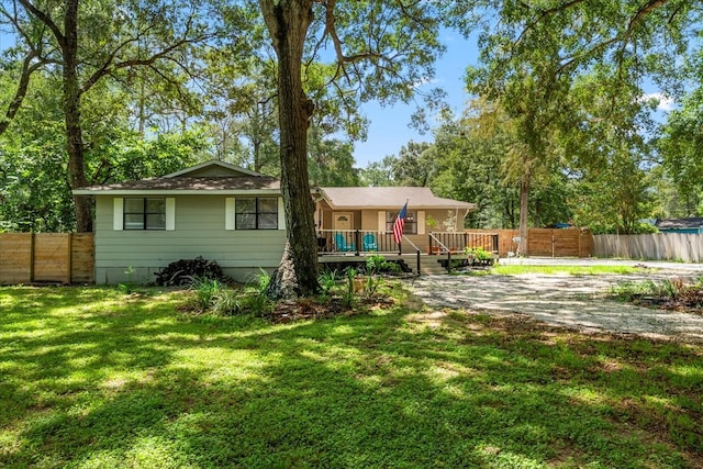 back of property featuring a deck and a yard